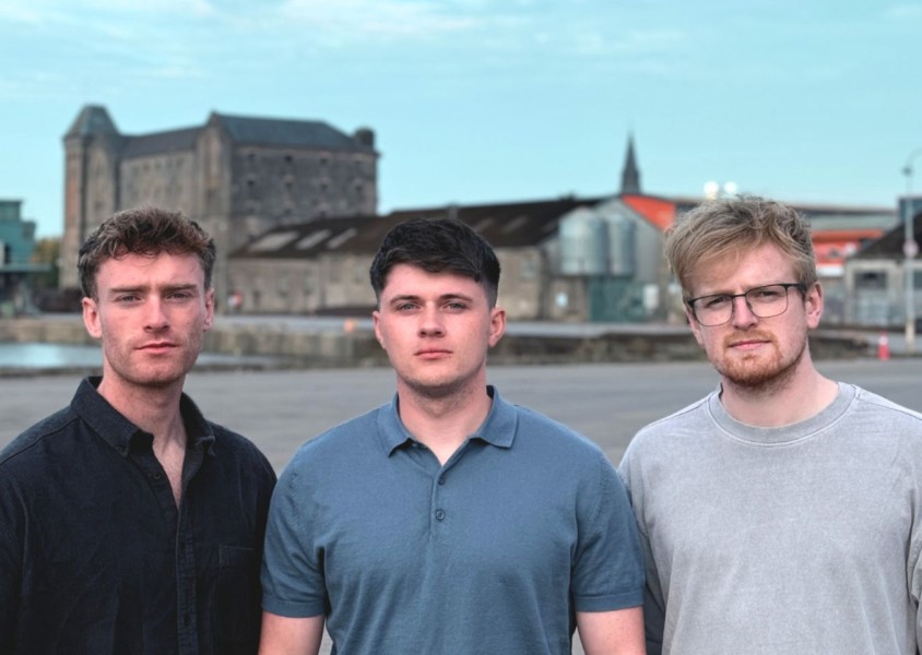 Three men stood against village background x